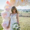 Blush colour beach wedding dress in outdoor setting