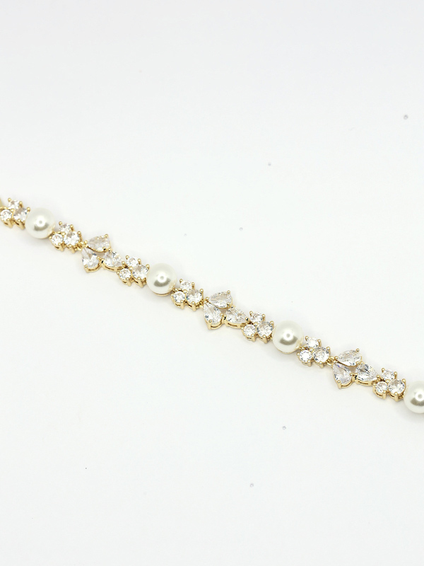 Gold and pearl wedding bracelets for bride.