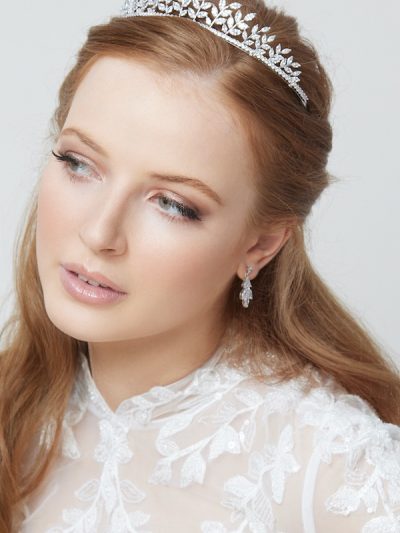 Princess wedding earrings in silver being worn on ears