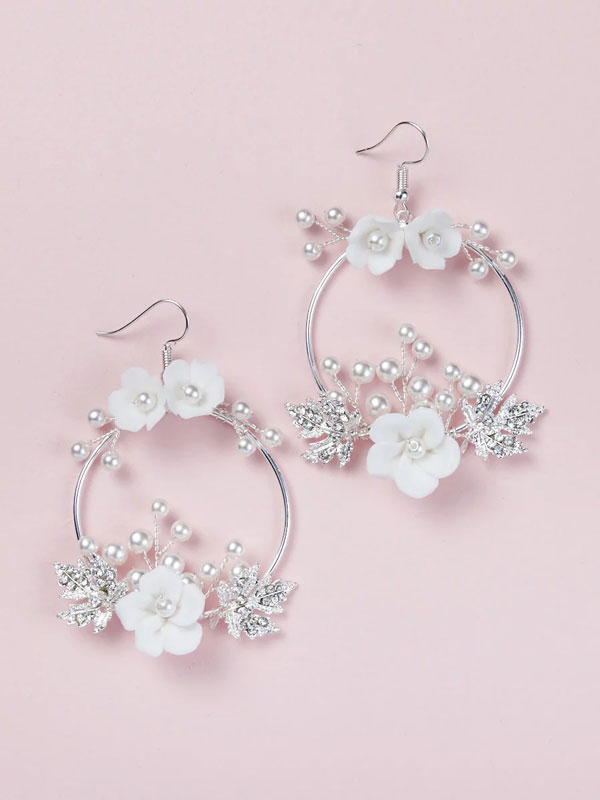 pair of silver hoop-style bridal earrings with off-white porcelain flowers and pearls
