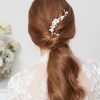 Long bridal comb in ivory colour surrounded by pearls.